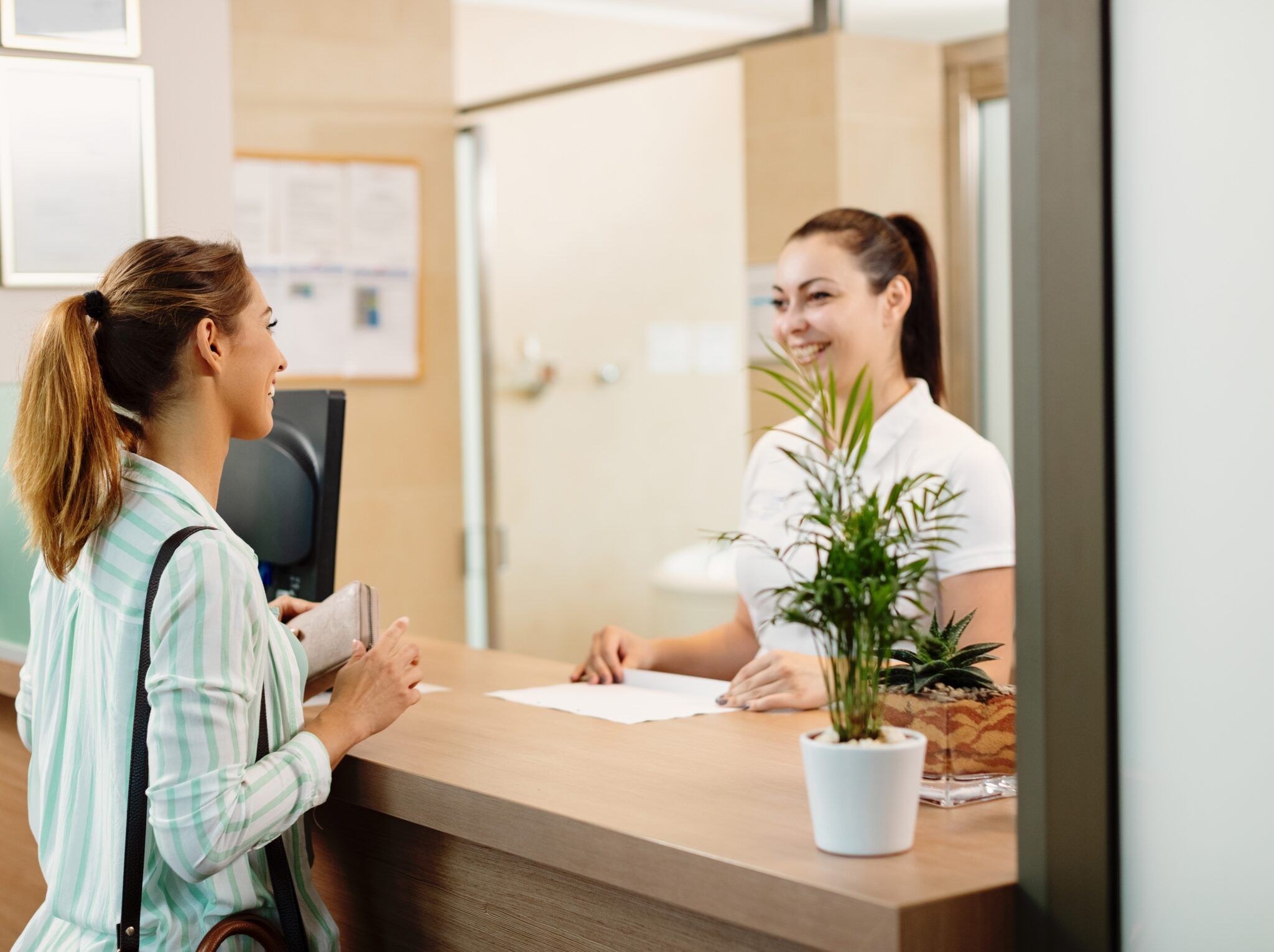 Happy Woman Talking Receptionist While Arriving Dentist 2048x1530