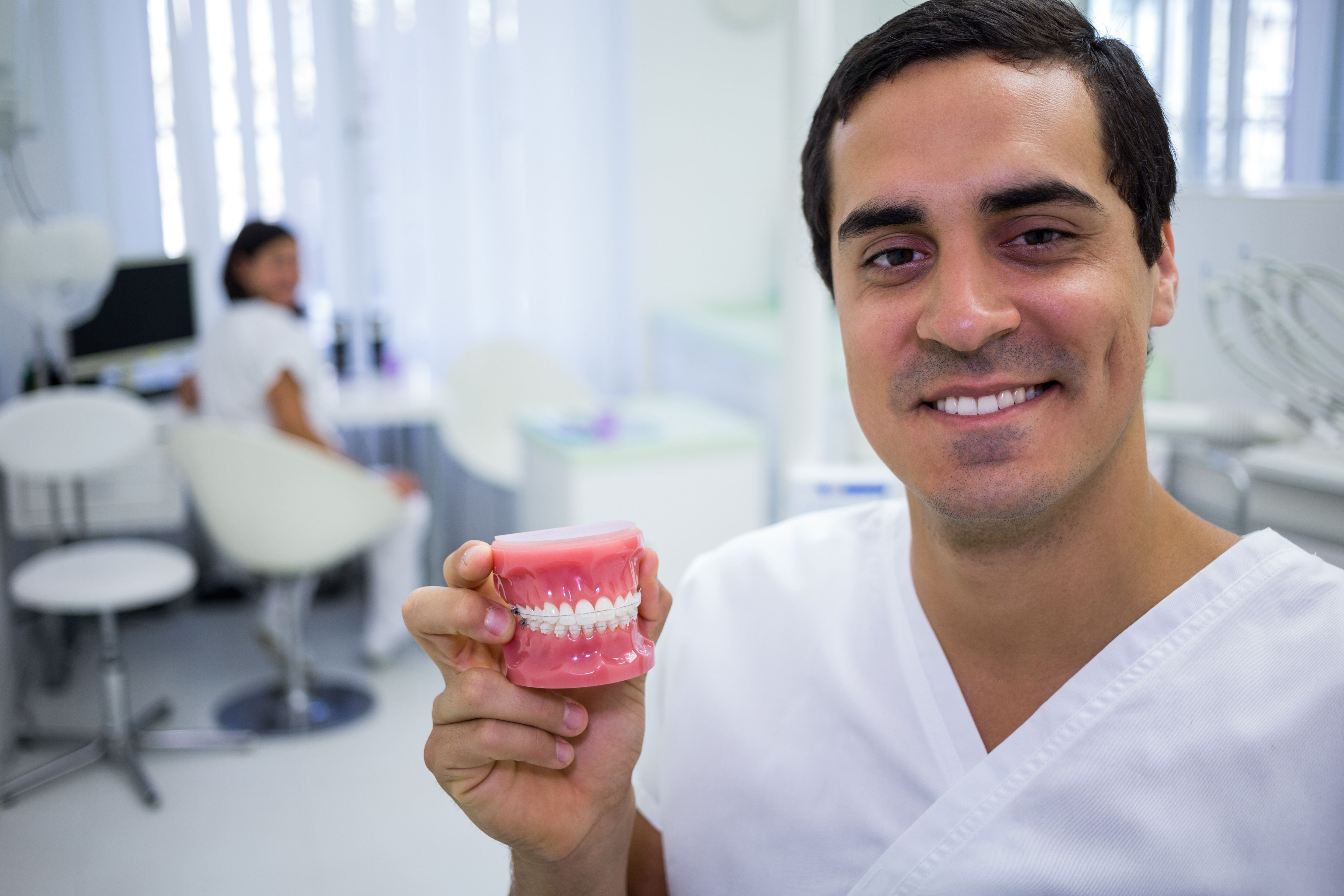Portrait Dentist Holding Set Dentures