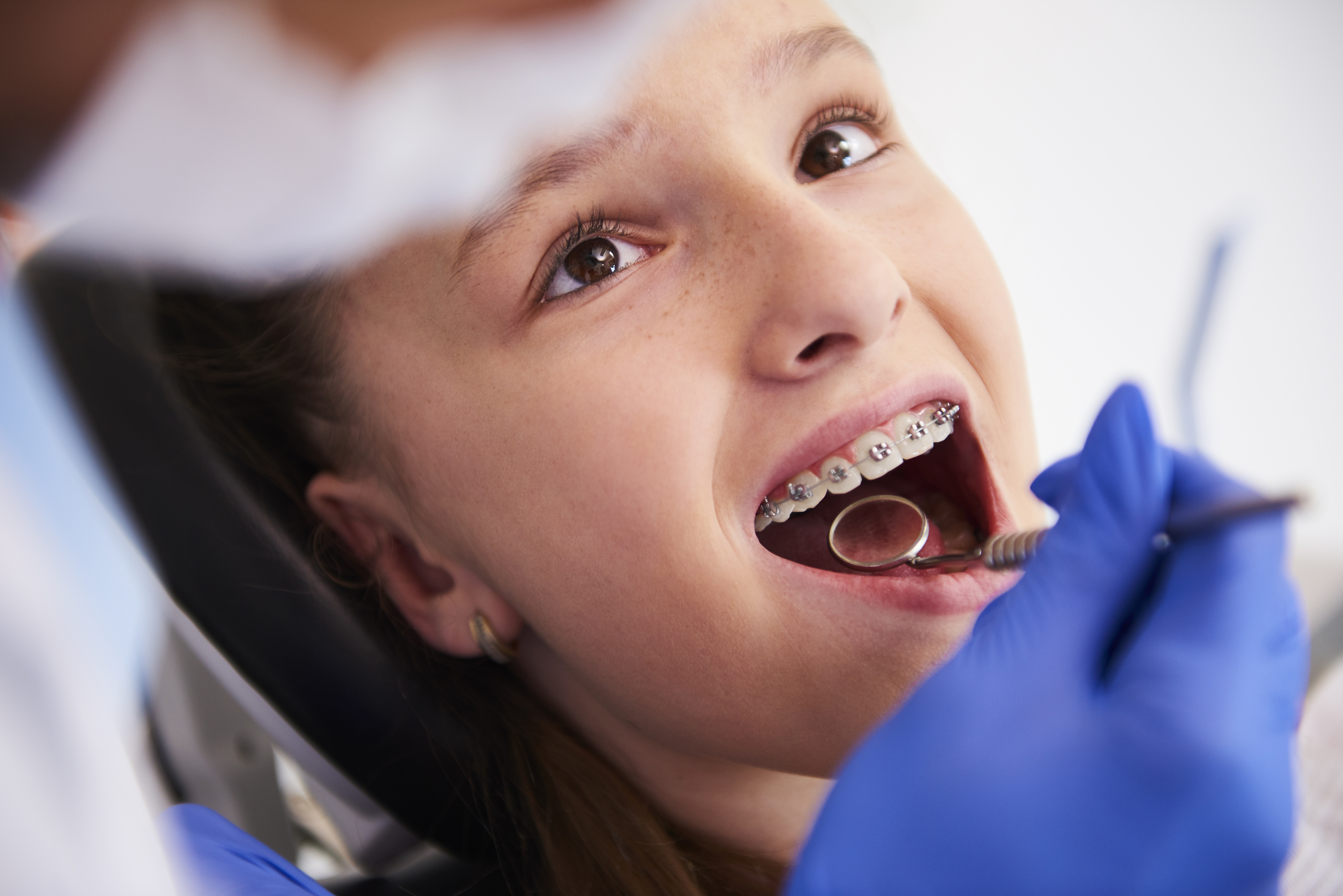 Girl With Braces Routine Dental Examination