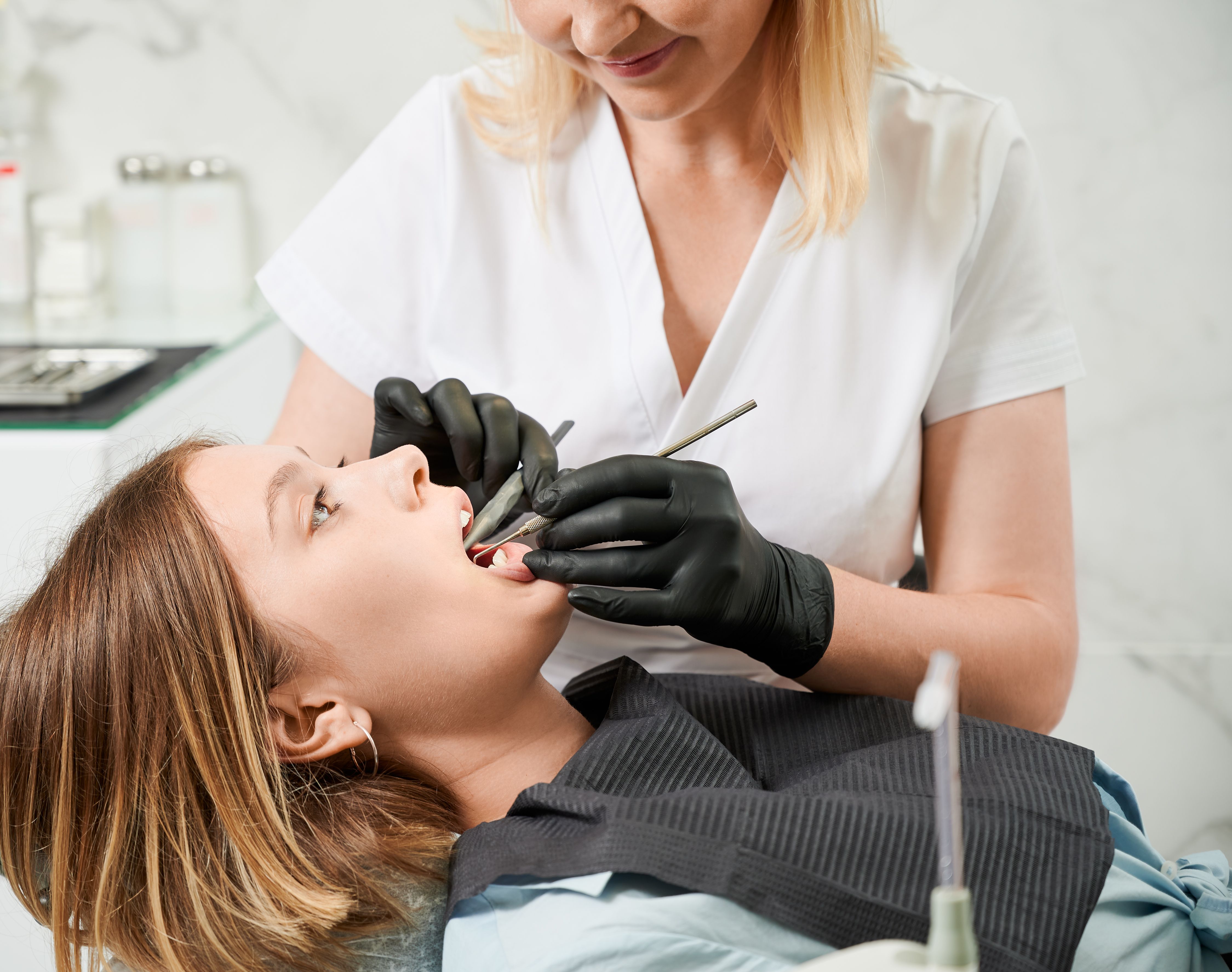 Female Doctor Examining Patient Teeth Dental Clinic
